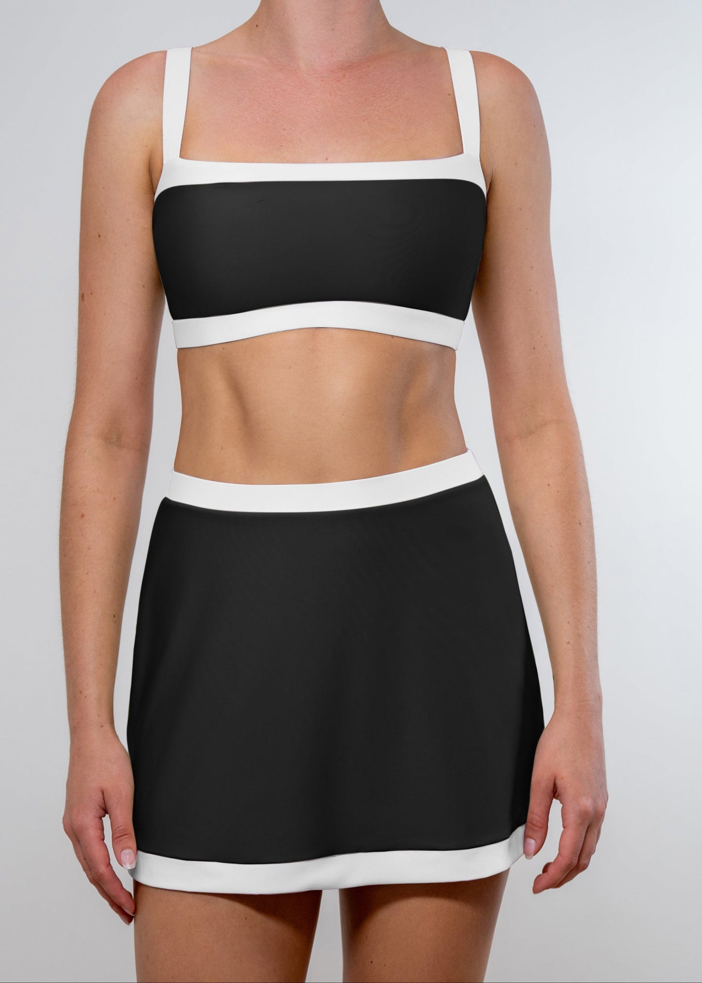 Black and white dress with a square neckline on a plain background